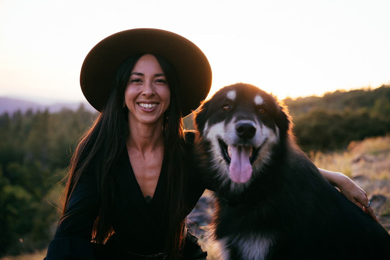 Jess smiling outdoors at dusk, a warm portrait of the caregiver behind Kindred Private Care